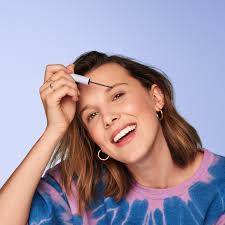 Her smoky eye makeup and perfectly messy hair are paired with a ruffled blouse. Millie Bobby Brown Wanted Her New Beauty Brand To Be Affordable And Fun To Use Teen Vogue