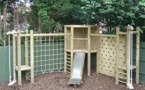 Corner Cabin And Scramble Frame Play Area Backyard Playground Landscaping Backyard Playground