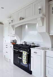 These dark grey cupboards are fantastically paired with the wooden window frames and chrome home equipment. Doran Kitchens Newry Bespoke Handmade Kitchen Suppliers Northern Ireland