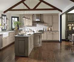 Sure, you could stain these rustic cabinets, but a coat or two of taupe paint adds a sophisticated element against planked walls. Taupe Kitchen Cabinets Decora Cabinetry