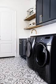 Dark Cabinetry Paired With Black Washer And Dryers In This Playful Yet Chic Laundry Room Savvy Inte Laundry Room Flooring Laundry Room Tile Laundry Room Design