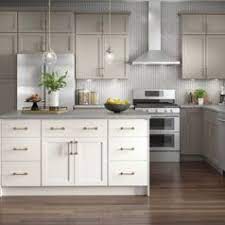 A kitchen remodel done using lowes white cabinets and glass backsplash. Kitchen Cabinetry