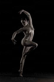 Full length view of nude woman in dancer pose stock photo