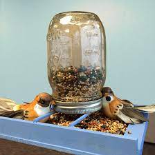Keep The Little Birdies Fed This Fall With This Diy Ball Jar Bird Feeder Just Glue Some Woodsies Slats And Dowe Diy Bird Feeder Bird Feeders Diy Bottle Crafts