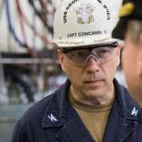 US Air Force (USAF) Major (MAJ) Mark Naumann, Program Manager, Airlift  Defensive Systems (ADS), Headquarters (HQ) Air Mobility Command (AMC),  Scott Air Force Base (AFB), Illinois (IL), watches aircraft from all over