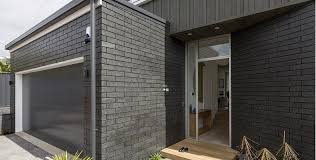 Dark grey siding with white trim, choosing exterior house colors on a lakeside cottage. The Block Nz Rooms Google Search Brick Exterior House Painted Brick House Grey Painted Brick House