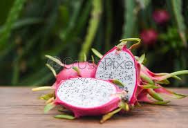 A pitaya (/pɪˈtaɪ.ə/) or pitahaya (/ˌpɪtəˈhaɪ.ə/) is the fruit of several different cactus species indigenous to the americas. Dragon Fruit Slice On Wooden With Dragon Fruit Tree Background Stock Photo Crushpixel