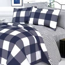 A complete sheet set features a contrasting navy flange that adds a bold accent to the sheet set, while a decorative pillow and navy bed skirt provides the finishing touches. Navy Blue And Gray Plaid Comforter Novocom Top