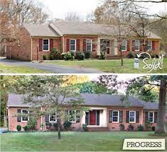 New large suburban red brick home with arched windows, side garage, grey shingles and gardens in the front yard. Front Door Colors With Red Brick Ranch Shutters 60 Ideas For 2019