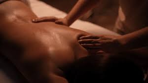 Masseuse Gently Applying Massage Oil On