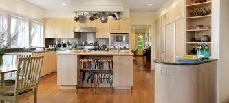 Contemporary Maple Slab Kitchen Simpson Cabinetry Chic kitchen features maple cabinets paired with statuary marble countertops and a white linear brick tile backsplash. simpson cabinetry