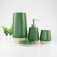 An olive green wall gives this bathroom a spacious and airy quality with plenty of natural light filtering in through electric lighting sets the tone for a space with a great organic vibe. Hot Sale Modern 4pcs Natural Green Bathroom Accessories Sets Soap Liquid Dispenser Concrete Bathroom Set