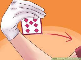 To prepare to throw it, hold it like you would with a baseball. How To Throw Cards Accurately Throwing Cards Easy Magic Card Tricks Magic Card Tricks
