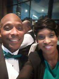 Locate man in purple shirt and white shorts?