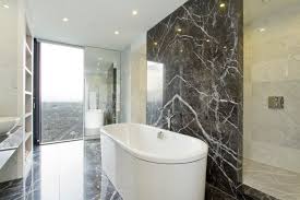Solid bar brass plated, floating marble custom writing desk with 50mm mitred black fantasy marble. 10 Spectacular Rooms With Marble Walls