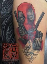 Black deadpool logo tattoo stencil. Arm Held Deadpool Tattoo Von Andys Body Electric