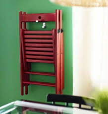 A Folding Ikea Chair In Red Wood Hung Up On A Hook On The Wall Smallfoldingchair Ikea Folding Chairs Ikea Small Spaces Tiny House Furniture