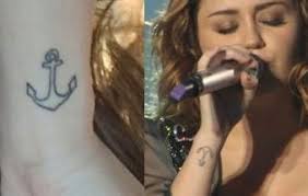 (characterized by what appears to be her wukong tattoo) with a wound showing raw flesh and held open with. Miley Anchor Tattoo Anchor Tattoos Miley Cyrus Tattoos