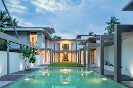 The compound wall is a simple contemporary design, which breaks at two points, on either side of the site, to form horizontal openings that give a glimpse of the serene landscape within. This Family Home In Kerala Makes A Case For Sustainable Architecture Architectural Digest India