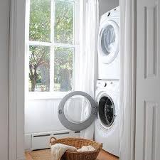 Install a shelf (with cutouts for the cords) in front of it, and put baskets on the shelf to hide. Stacked Washer Dryer Behind Curtains Design Ideas