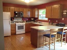 Red Accent Wall In Kitchen With Brown Cabinets Google Search Kitchen Color Dark Cabinets Kitchen Design Honey Oak Cabinets