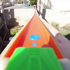 Home made wall mounted hot wheels track : Ride On A Hot Wheels Car Through A Two Story Yard Filling Track