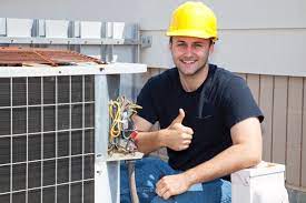 HVAC technician working on system