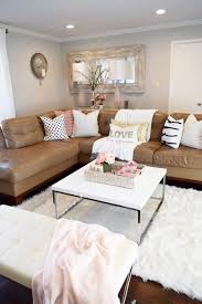 Refresh Your Living Room With A Few Key Pieces A New Throw A Couple Pillows Faux Flower Arrangements And A Tan Living Room Couch Decor Tan Couch Living Room