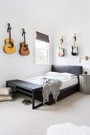 Submitted 3 years ago * by why_not_zoidberg56. Boys Bedroom Featuring Guitars Mounted As Art Over The A Leather Bed Finished With A Black Woven Bench At Bedroom Design Guitar Bedroom Ideas Music Room Decor