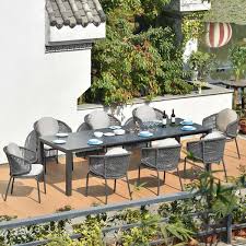 Stylish dining table has attractive ceramic tile top. 9 Pieces Aluminum Outdoor Dining Set With Stone Top Extendable Dining Table