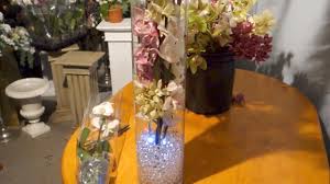 Use a mix of tall candlesticks and short vases to avoid blocking anyone's dinnertime view. How To Make A Wedding Centrepiece With Orchids And Led Lights Youtube