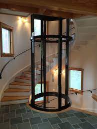 Vuelift Round In Spiral Staircase With Windows Glass Elevator House Elevator Elevator Ideas Elevator Tiny House Stairs House Lift Small House Lifts