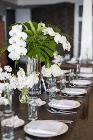 Wedding Centerpieces White Phaelaenopsis Orchids Monstera Leaves Palms Tropical Wedding Centerpieces Flower Centerpieces Wedding Orchid Centerpieces Wedding