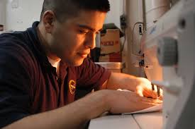 File:US Navy 030227-N-9403F-003 Ship's Serviceman Seaman Mitchell Sanchez  from Dallas, Texas, sews
