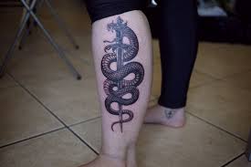 Black snake tattoo on the leg. 28 Snake Tattoos On Leg