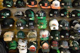 The Uh Bookstore Has A Huge Selection Of Caps Visors And Snapbacks On The Hat Wall Makemanoayours Warrior Gear Rainbow Warrior Hat Wall