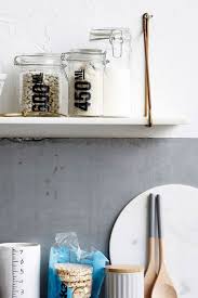 Floating brass shelves in midcentury modern kitchen. White Marble Shelf Rockett St George