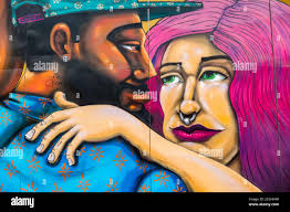 Graffiti or street art adorning the wall of a narrow walkway in Albaicin,  Granada, Spain Stock Photo