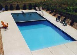 Hidden Automatic Pool Cover Could Be The Perfect Solution Easy On Off Keeps Leaves And Dirt Out Automatic Pool Cover Backyard Pool Landscaping Outside Pool