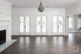 We'll be using shiplap for walls and a cathedral ceiling in our new construction cabin. White Shiplap Living Room With Gray Beaded Chandelier Transitional Living Room