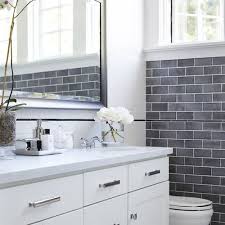 Glossy white subway tile is laid in a traditional install in this kitchen. Beautiful Bathrooms With Subway Tile