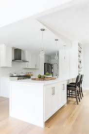 Modular kitchen cabinets are laminated in a simple matte white color and uses concealed hinges and stainless steel handles and appliances, while the counter top material is white solid. 25 Best White Kitchens With Space Saving Style Ideas Photos And More