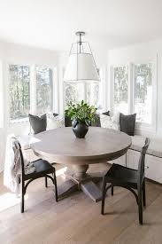 A Hanging Shade Lights Illuminates A Round Oak Dining Table Matched With Black Wooden Dining Chairs And Transitional Dining Room Dining Room Design Dining Nook