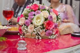 Groom's cake, decorated according to his life Colorfull Wedding Flowers Bride And Groom With Engagement Gold Rings Put On The Table And Next