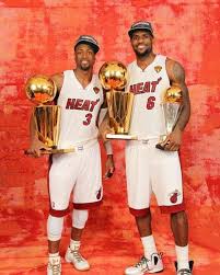 Dwyane Wade And Lebron James Of The Miami Heat Poses For A Portrait With Both Larry O Brien Trophies And The Miami Heat Basketball Nba Miami Heat Nba Champions