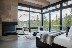 The Master Bedroom In John Thompson And Cody Goettle S Contemporary Home In Big Sky Mont In 2020 Big Windows Living Room Living Room Windows Glass House Design