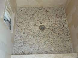 Install pebble tile stone floors first. Flat White Pebbles Shower Floor Used In Secondary Baths Shower Floors No Tubs In This House Pebble Shower Floor Mosaic Shower Tile Shower Floor