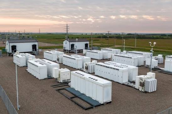 Rows of industrial battery energy storage units installed beside a solar power plant in India