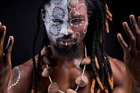 black male model doing ritual isolated over black background, portrait of  man in national wear on naked body, tribal maya aborigen, shaman Stock  Photo | Adobe Stock