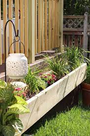 It's spray painted a modern blue color, has the diamond spaces in between, and is the perfect deck planter box for this summer. Flower Box On The Side Of Deck Flower Boxes Wooden Flower Boxes Flower Boxes Deck